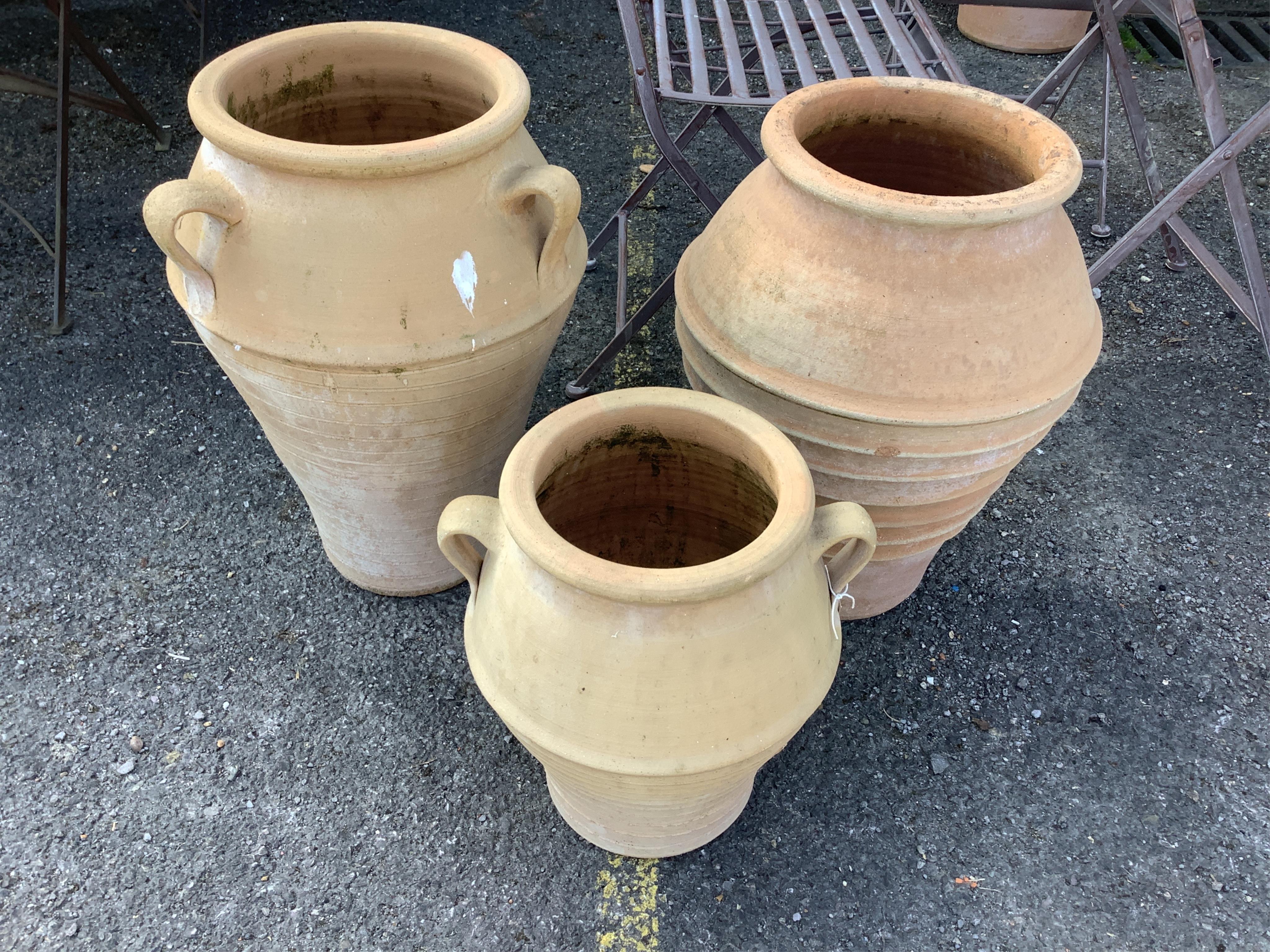 Three Grecian style circular terracotta garden planters, height 55cm